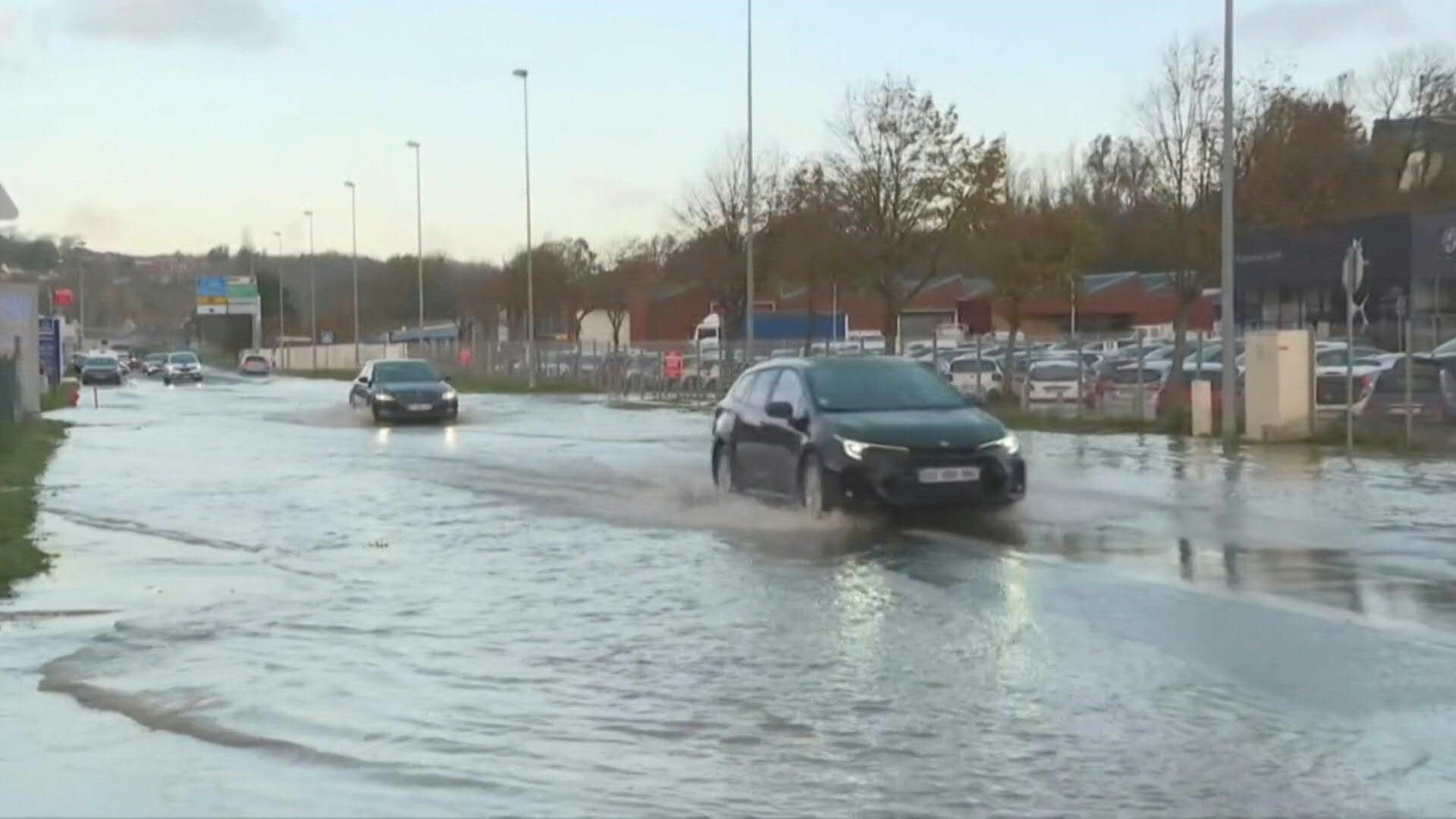 Cars crawl along water-logged roads in flood-hit northern France