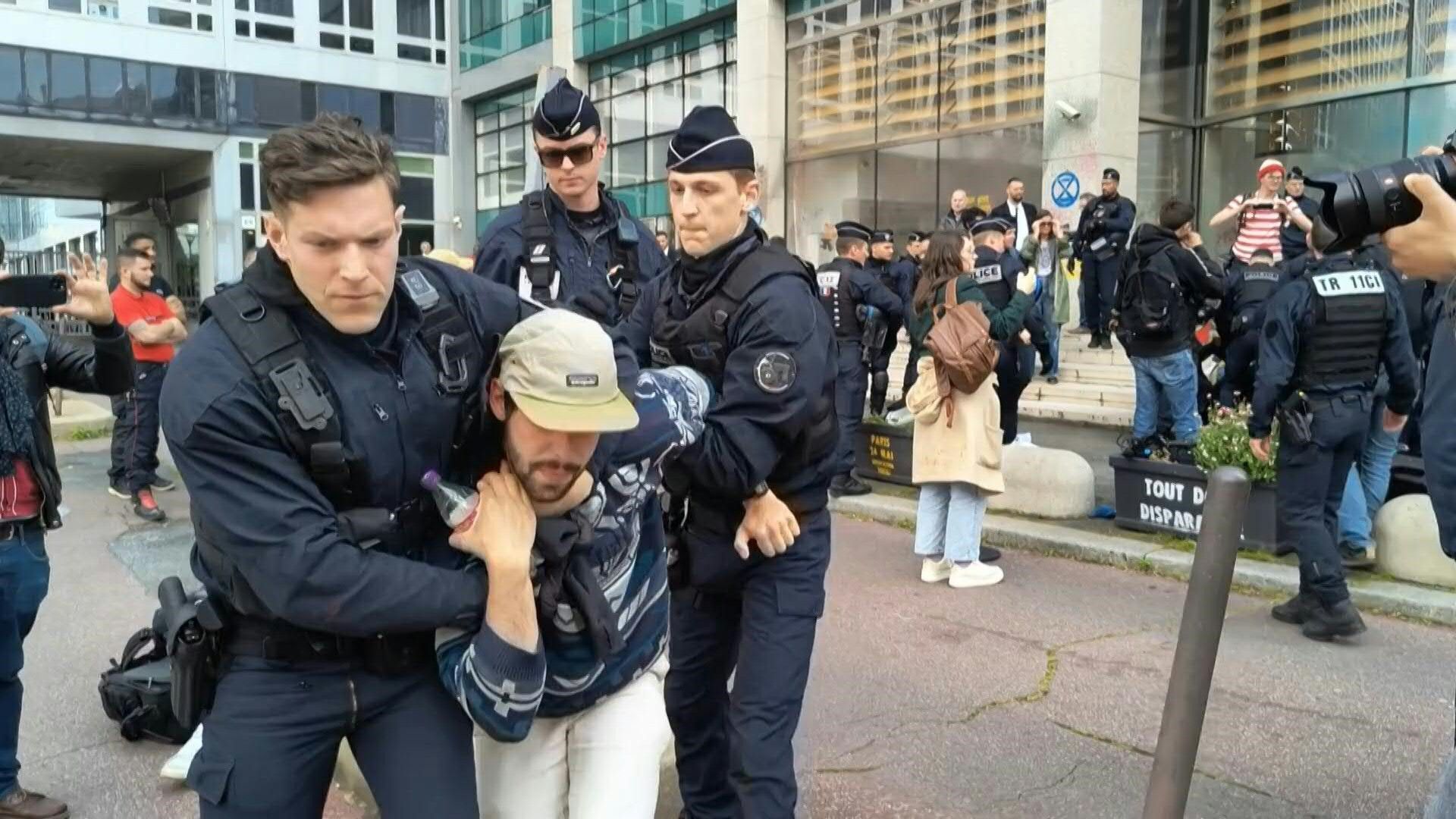 Police remove Extinction Rebellion activists outside Amundi HQ in Paris