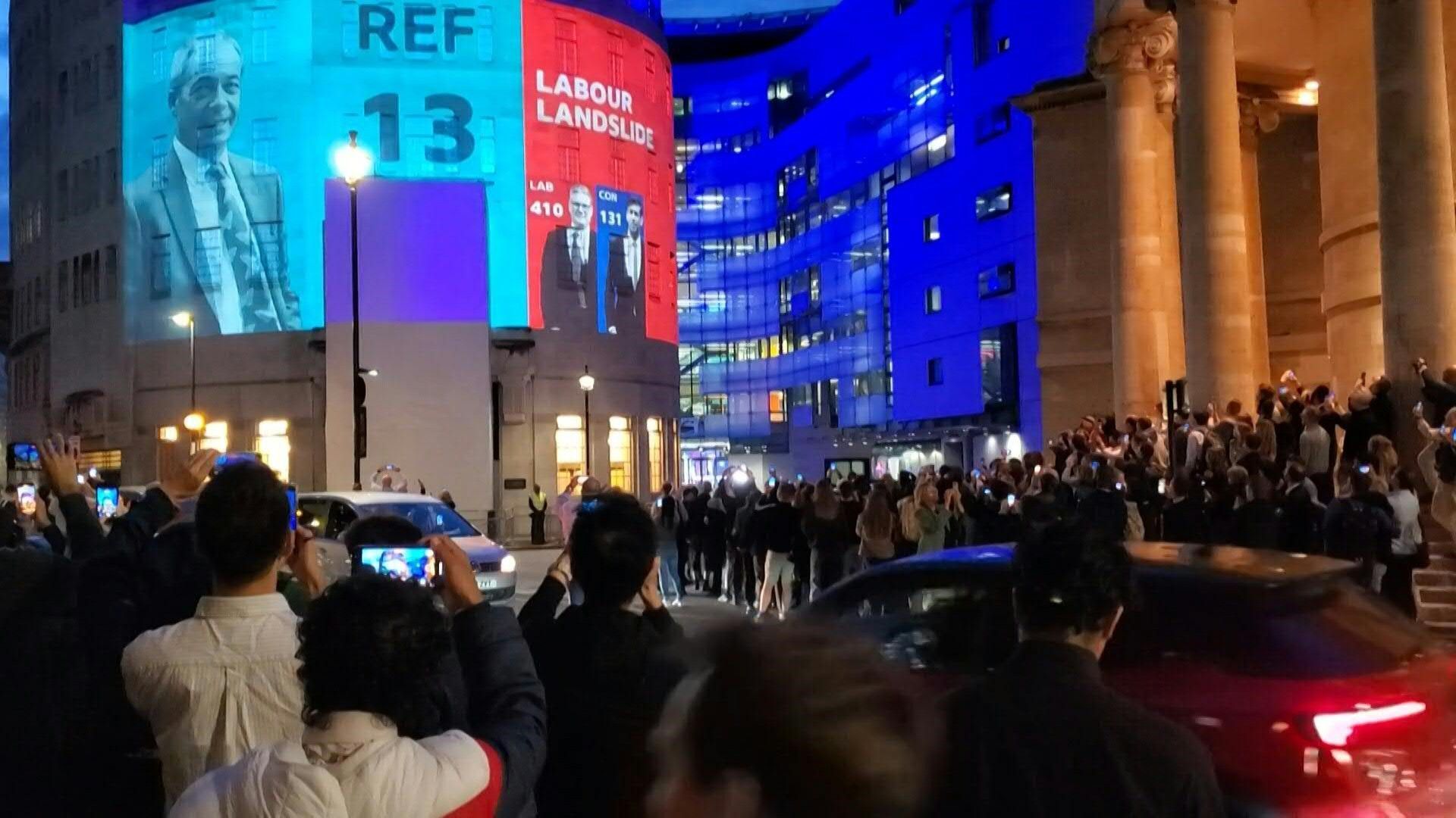 People cheer as exit polls projected onto BBC HQ show Labour landslide ...