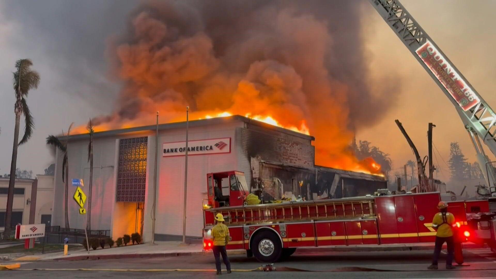 Firefighters continue to fight flames during the Eaton fire in the Altadena area of LA