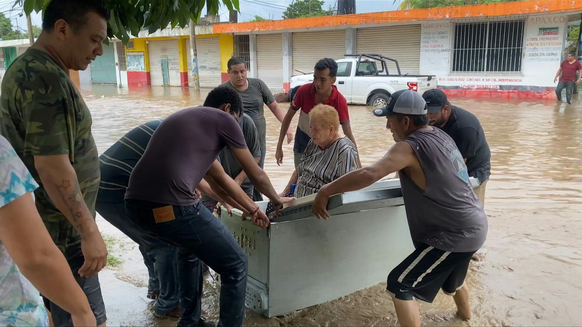 Video: Woman rescued in flooded Veracruz town using fridge as makeshift boat after heavy rains