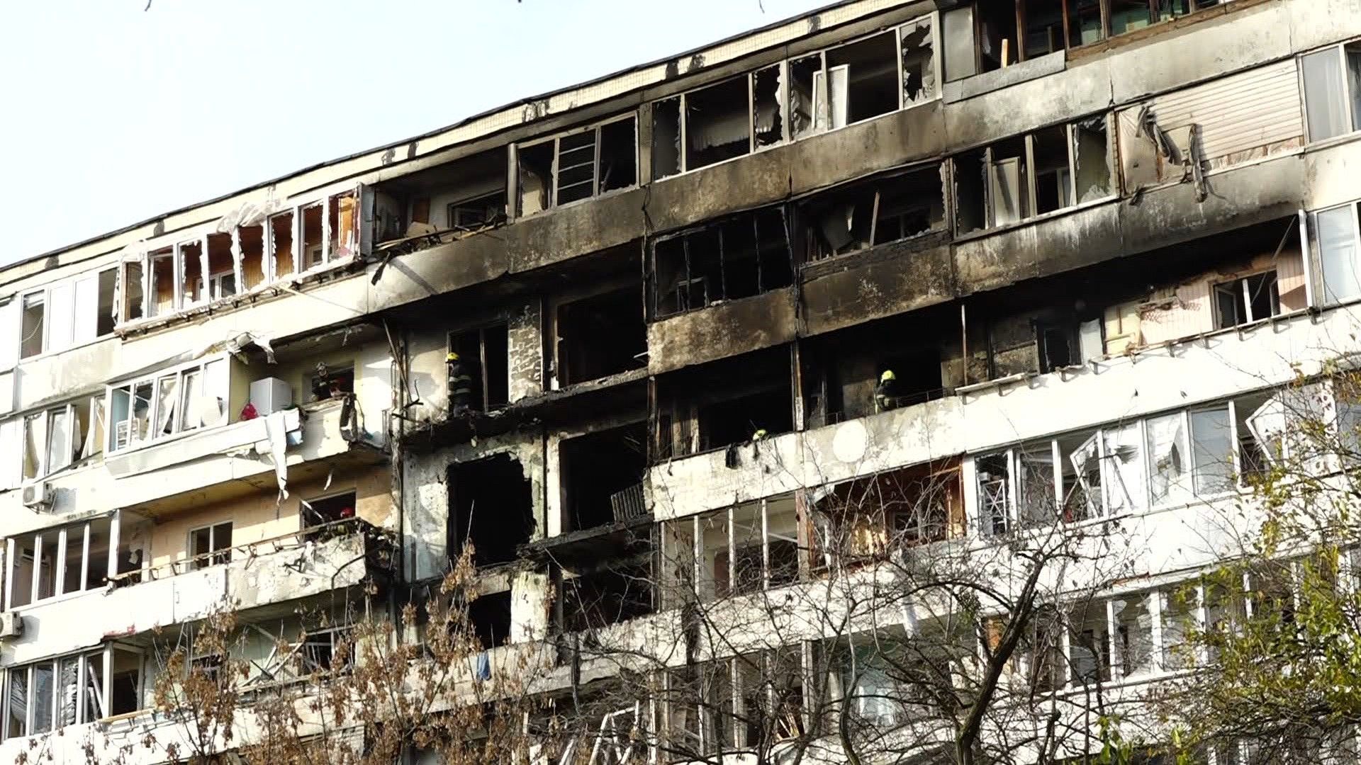 Firefighters clear debris from Kyiv apartment block hit by Russian strike
