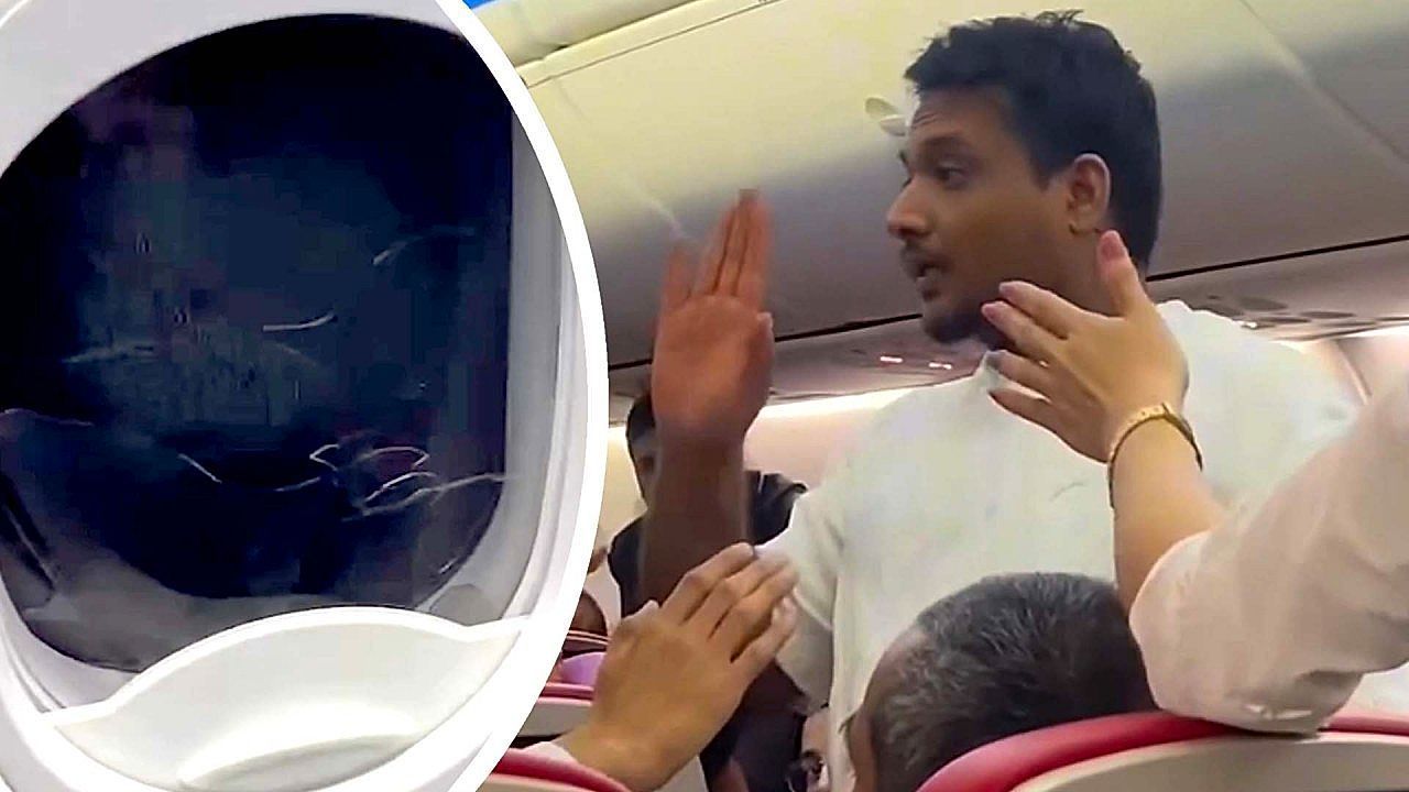 Video: Passenger smashes emergency exit window and tries to open door mid-flight